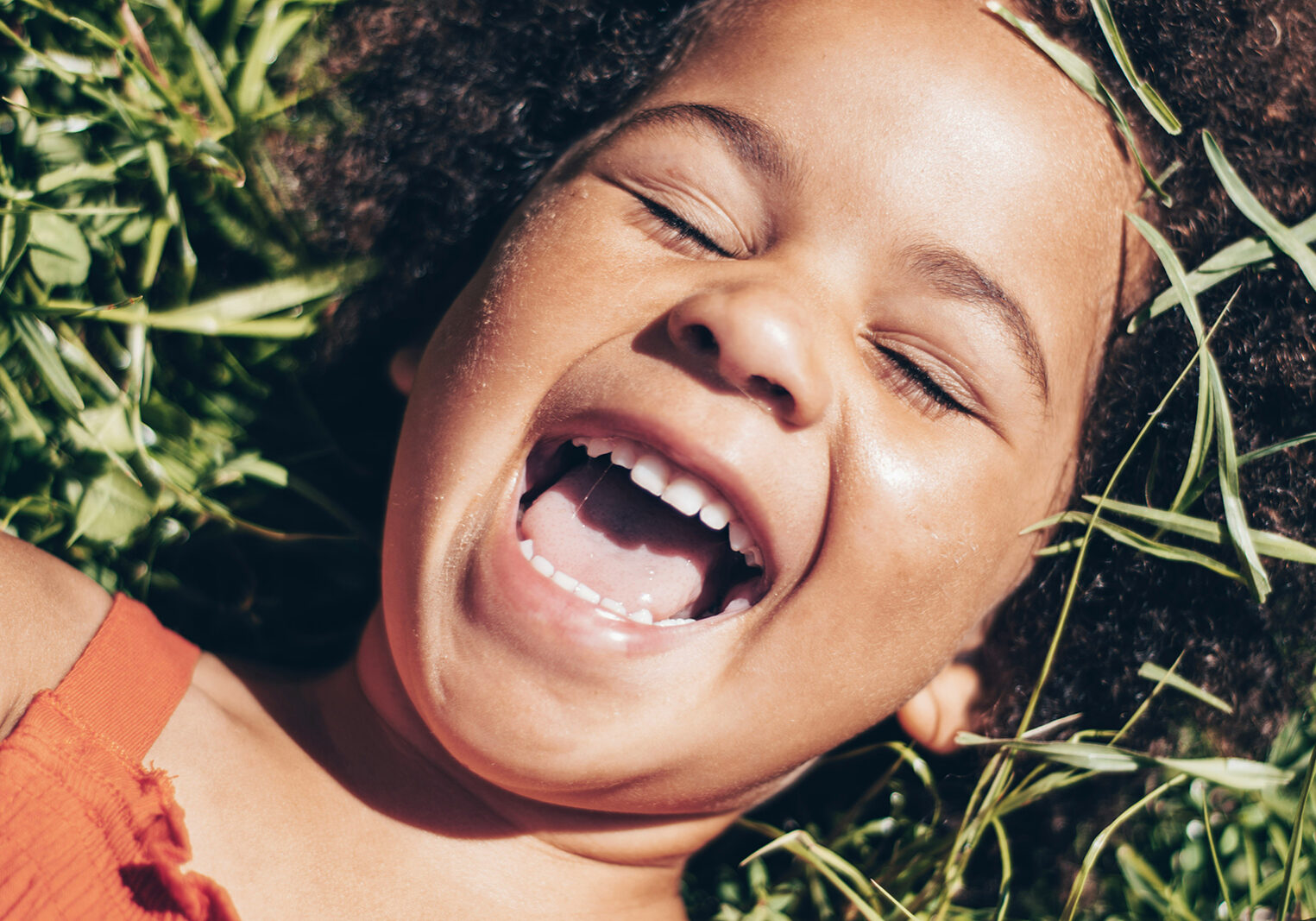 Little girl smiling outside